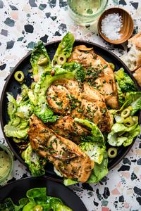 homemade chicken paillard on a plate with a salad