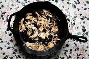 garlic and shallots in a cast iron pan with butter and olive oil