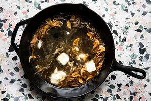 chicken pan sauce with butter and olive oil, garlic and shallots in a cast iron skillet