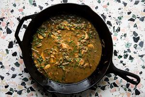 chicken pan sauce with butter and olive oil, garlic, shallots and chives in a cast iron skillet