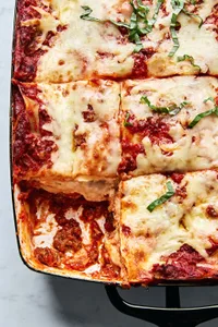 a pan of classic lasagna made with meat sauce, mozzarella, Parm, ricotta, and al dente lasagna noodles
