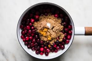 Cranberries, Apple cider vinegar, brown sugar, cloves, cinnamon, salt, vanilla & orange juice and zest in a saucepan