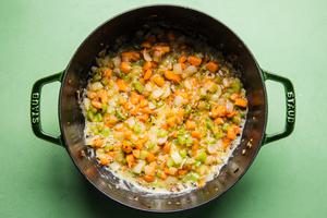 onions, carrots, celery, garlic butter and flour being cooked in a pot