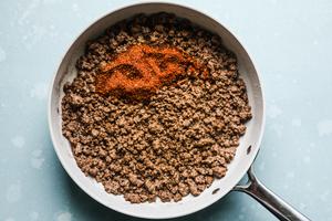 ground beef in a skillet with taco seasoning