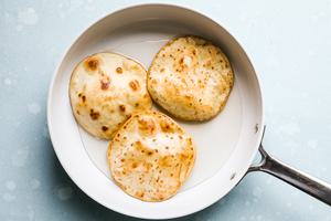 flour tortillas in a skillet fried in vegetable oil