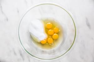 eggs and sugar in a glass bowl