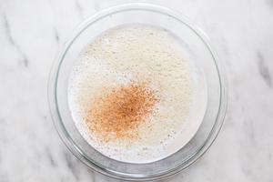 eggs, milk, cream, bourbon, rum and nutmeg blended in a glass bowl