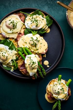 eggs benedict with hollandaise sauce on English muffins with ham and asparagus and poached eggs