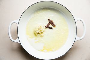 butter garlic and anchovies in a braising dish