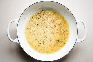 butter garlic and anchovies in a braising dish with white wine