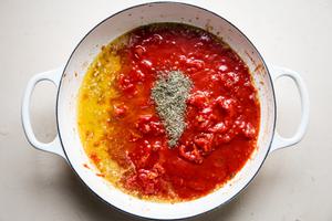puttanesca sauce with butter, garlic, anchovies white wine, salt and pepper in a braising dish