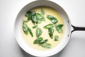 melted butter and sage leaves in a skillet