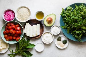 ingredients for Grilled Halloumi Salad arugula, avocado, tomatoes, pickled onions, basil and panko