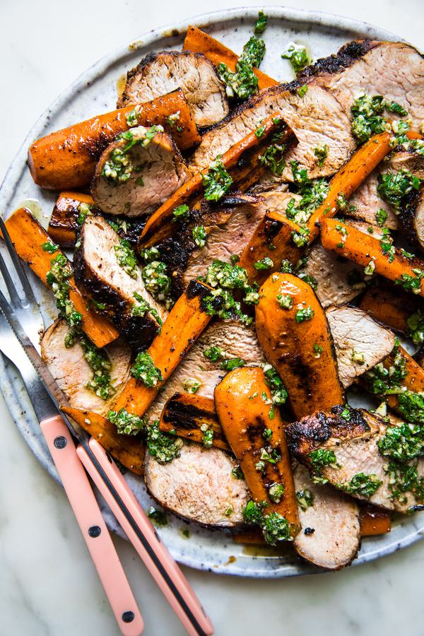 Grilled Pork Tenderloin with Carrots and Chermoula on a plate with a fork and knife
