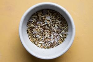 dried minced onion, salt, fennel seeds, sesame seeds, cumin seeds in a bowl