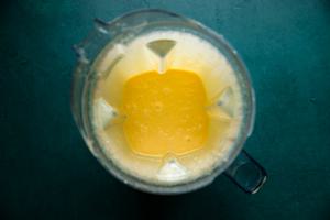 homemade hollandaise sauce in the base of a blender made with egg yolks, butter and fresh lemon juice