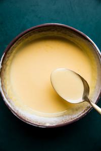a bowl of homemade hollandaise sauce made with egg yolks, butter and fresh lemon juice