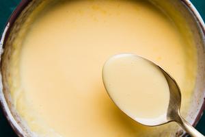 a bowl of homemade hollandaise sauce made with egg yolks, butter and fresh lemon juice