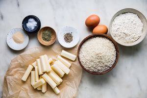 Flour, Eggs, Panko, seasonings and mozzarella cheese sticks on the counter to make homemade breaded mozzarella sticks