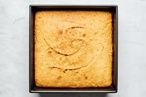 homemade cornbread warm out of the oven in a 9x9 baking dish
