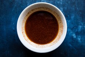 honey, olive oil, cayenne pepper, chili powder, salt, pepper, ginger and garlic powder mixed together in a bowl.