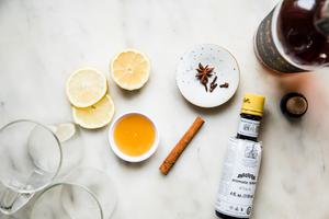 cinnamon stick, cloves, star anise, honey, lemon juice, bitters, bourbon and lemon slices to make a hot toddy