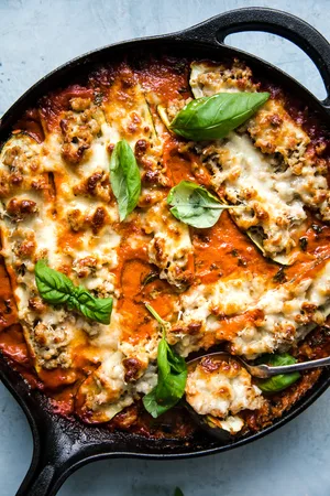 Italian Stuffed Zucchini Boats with creamy tomato sauce, parmesan and mozzarella cheese with basil