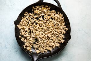 ground chicken and spices in a cast iron skillet
