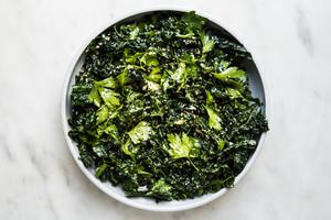 Kale Salad with Lemon Parmesan Dressing, parsley tossed together in a bowl