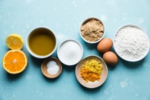 orange, lemon, zest, brown sugar, white sugar, flour, olive oil, eggs, salt and baking powder for olive oil cake
