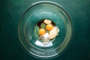 eggs, Worcestershire sauce, Dijon, salt, pepper, garlic powder and onion powder in a mixing bowl on the counter