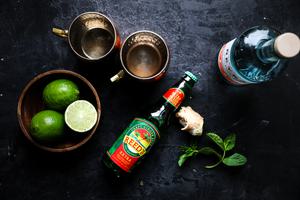 ginger beer, limes, vodka and mint prepped to make a moscow mule
