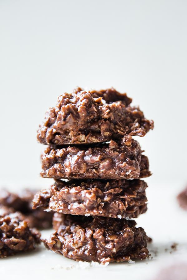 a stack of no-bake cookies on the counter made with Milk, Butter, Cocoa powder, Sugar, Oats, Peanut butter, Vanilla and Salt