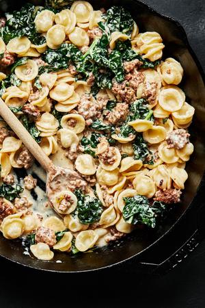 close up of orecchiette kale pasta with Italian sausage cream sauce