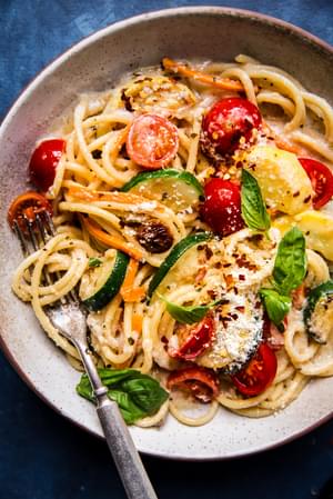 homemade pasta primavera in a bowl made with zucchini, tomatoes, carrots and basil