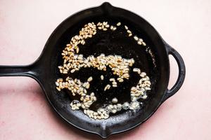 pine nuts and butter cooking in a skillet