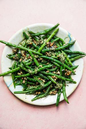 pesto green beans with pine nuts on a plate