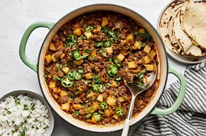 picadillo topped with fresh cilantro and jalapeños, served with rice and a warm tortillas on the side