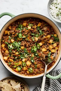 picadillo topped with fresh cilantro and jalapeños, served with rice and a warm tortillas on the side
