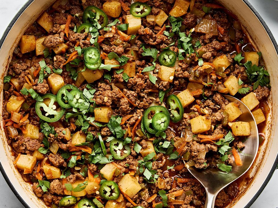 picadillo topped with fresh cilantro and jalapeños, served with rice and a warm tortillas on the side