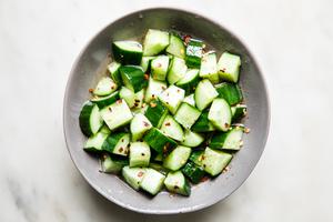 A bowl of refreshing cucumber salad in a tangy dressing made from rice vinegar, sugar, salt, red pepper flakes & sesame oil.