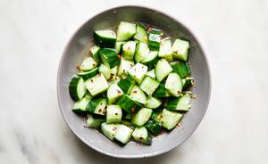 A bowl of refreshing cucumber salad in a tangy dressing made from rice vinegar, sugar, salt, red pepper flakes & sesame oil.
