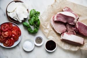 pork chops, tomato slices, balsamic glaze, basil, fresh mozzarella salt and pepper in prep bowls to make pork caprese