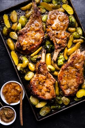 4 seared pork chops on a sheet pan with apricot jam, mustard and butter with Brussels sprouts and fingerling potatoes