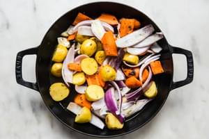 apples, carrots and potatoes in a dutch oven