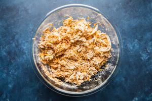 shredded chicken, cheese, sour cream and taco seasoning stirred together in a bowl for red enchilada filling