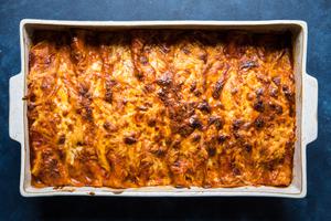 homemade red chicken enchiladas in a baking dish