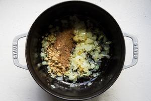 coconut oil, garlic, onion, garam masala, ground ginger, turmeric, cinnamon and cumin in a pot for red lentil soup