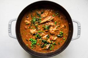 homemade red lentil soup made with chicken, peas and spinach in a large soup pot