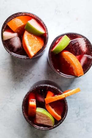 Red Wine Sangria Recipe with cinnamon, apples, oranges, brandy and triple sec.